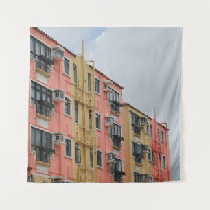 YELLOW AND RED CONCRETE BUILDING UNDER WHITE CLOUD TAPESTRY