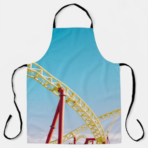 Yellow and red roller coaster under blue sky at da apron