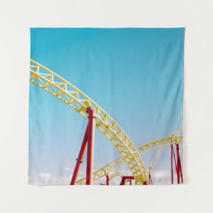 Yellow and red roller coaster under blue sky at da tapestry