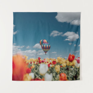 Yellow and red tulip flowers under hot air balloon tapestry