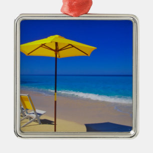 Yellow beach umbrella and chairs on pristine metal tree decoration
