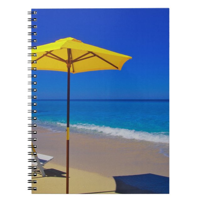 Yellow beach umbrella and chairs on pristine notebook (Front)