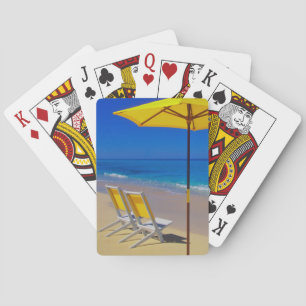 Yellow beach umbrella and chairs on pristine playing cards