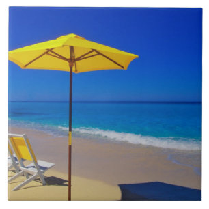 Yellow beach umbrella and chairs on pristine tile
