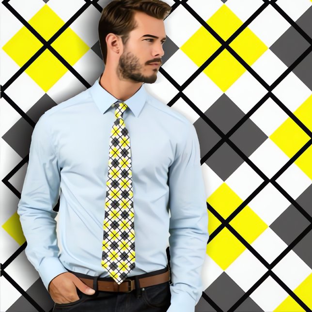 Yellow, Black, Grey on White Argyle Print Necktie (Man in yellow argyle tie standing again yellow argyle background.)