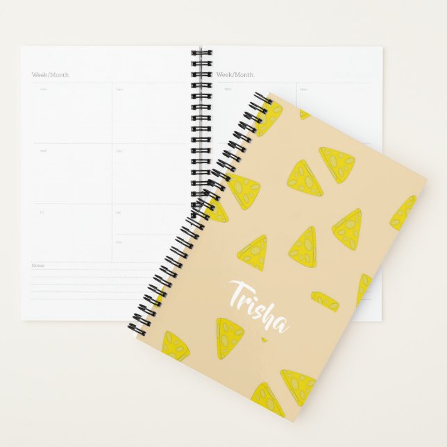 Yellow cheese shapes on pink planner (Display)