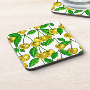 Yellow cherries on white coaster