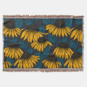 Yellow coneflowers on dark blue throw blanket