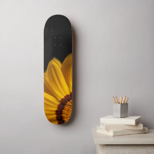 Yellow flower on  black background skateboard