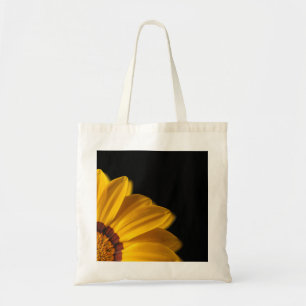 Yellow flower on  black background tote bag
