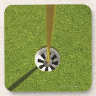 Yellow golf flag pole and hole coaster