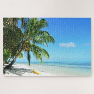 Yellow kayak on a white beach with palm jigsaw puzzle