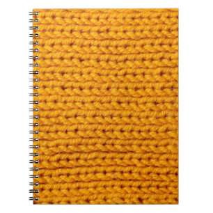 Yellow knitted wool texture background pattern wit notebook