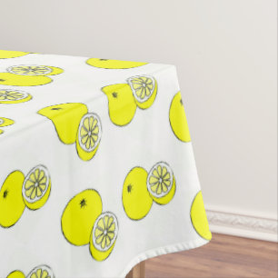 Yellow lemon fruits on white tablecloth