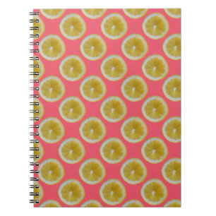 Yellow lemon slices on pink notebook