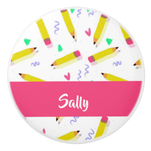 Yellow pencils and scrabbles on white ceramic knob
