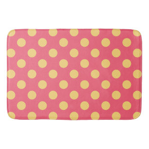 Yellow polka dots on coral bath mat
