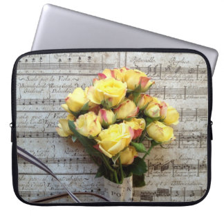 Yellow roses on old music laptop sleeve