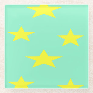 Yellow stars on turquoise glass coaster