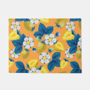 Yellow strawberries on orange doormat