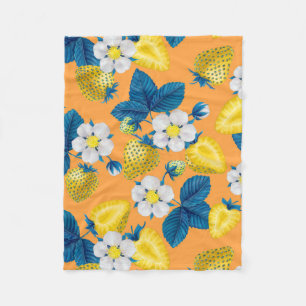 Yellow strawberries on orange fleece blanket