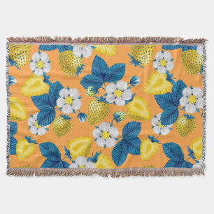 Yellow strawberries on orange throw blanket