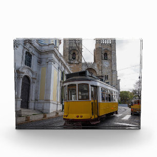 Yellow tram on Lisbon Cathedral in Portugal Photo Block