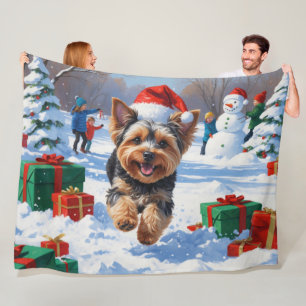 Yorkipoo Running in Snow with Christmas Hat Fleece Blanket