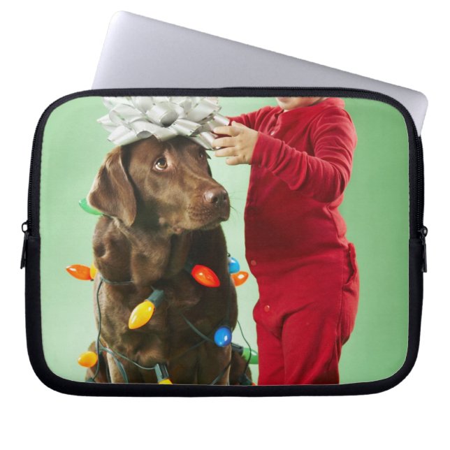 Young boy wrapping Christmas lights around a dog Laptop Sleeve (Front)