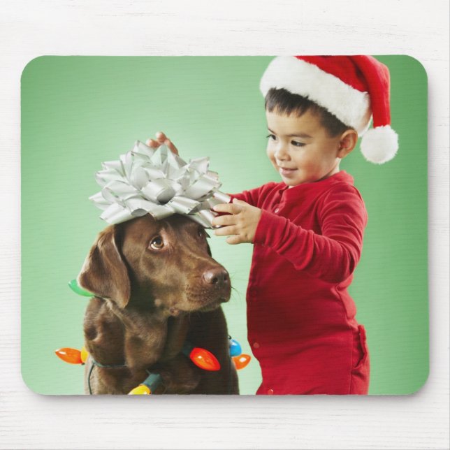 Young boy wrapping Christmas lights around a dog Mouse Mat (Front)