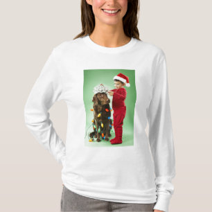Young boy wrapping Christmas lights around a dog T-Shirt