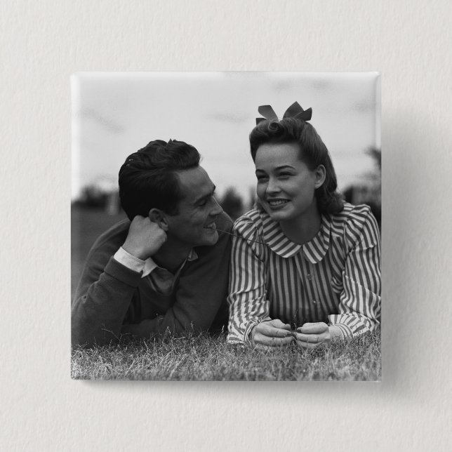 Young couple lying on grass 15 cm square badge (Front)