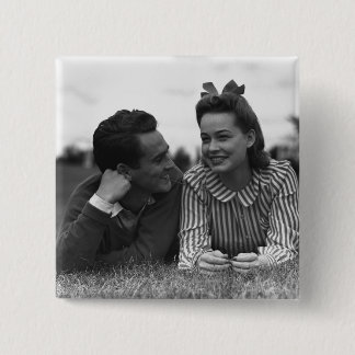 Young couple lying on grass 15 cm square badge