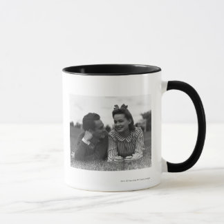 Young couple lying on grass mug