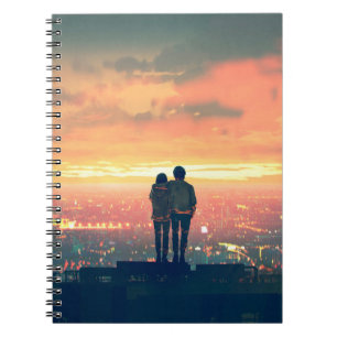 young couple standing on the roof top looking at c notebook
