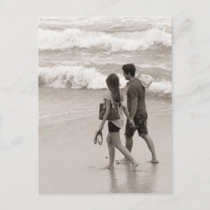 Young couple walking on the beach postcard