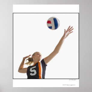 Young girl (16-17) playing volleyball poster