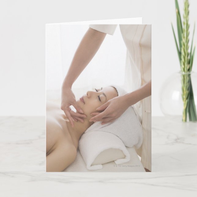 Young woman having facial massage card (Front)