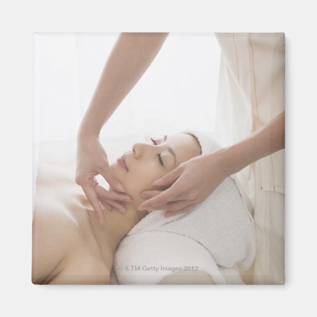 Young woman having facial massage magnet (Front)