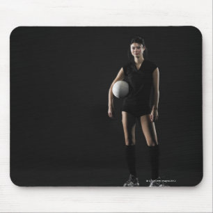 Young woman holding volleyball, portrait mouse mat