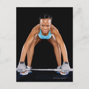 Young woman lifting barbell, portrait postcard