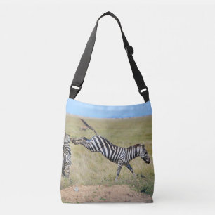 Zebra kicking up. Africa, Serengeti Crossbody Bag